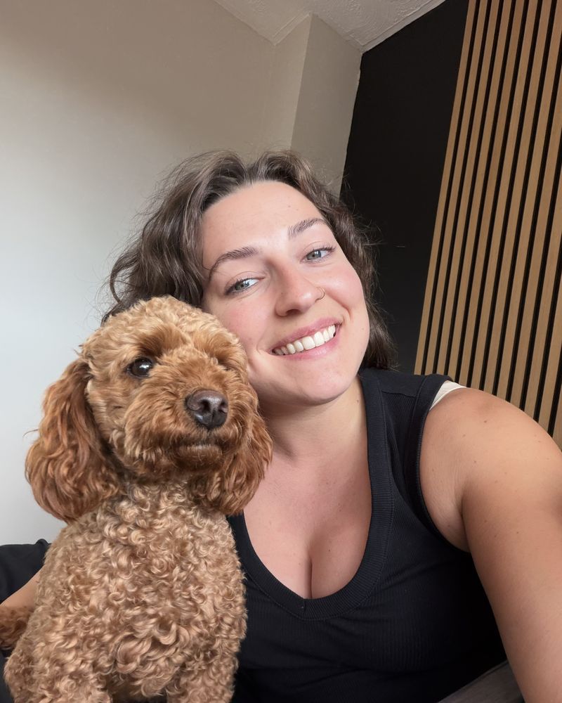 Hannah smiling with her dog, Maple