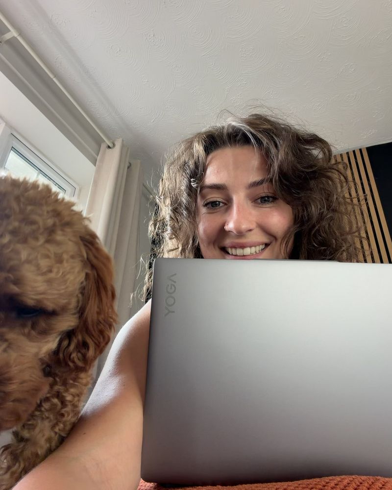 Hannah at her laptop, with Maple leaning in